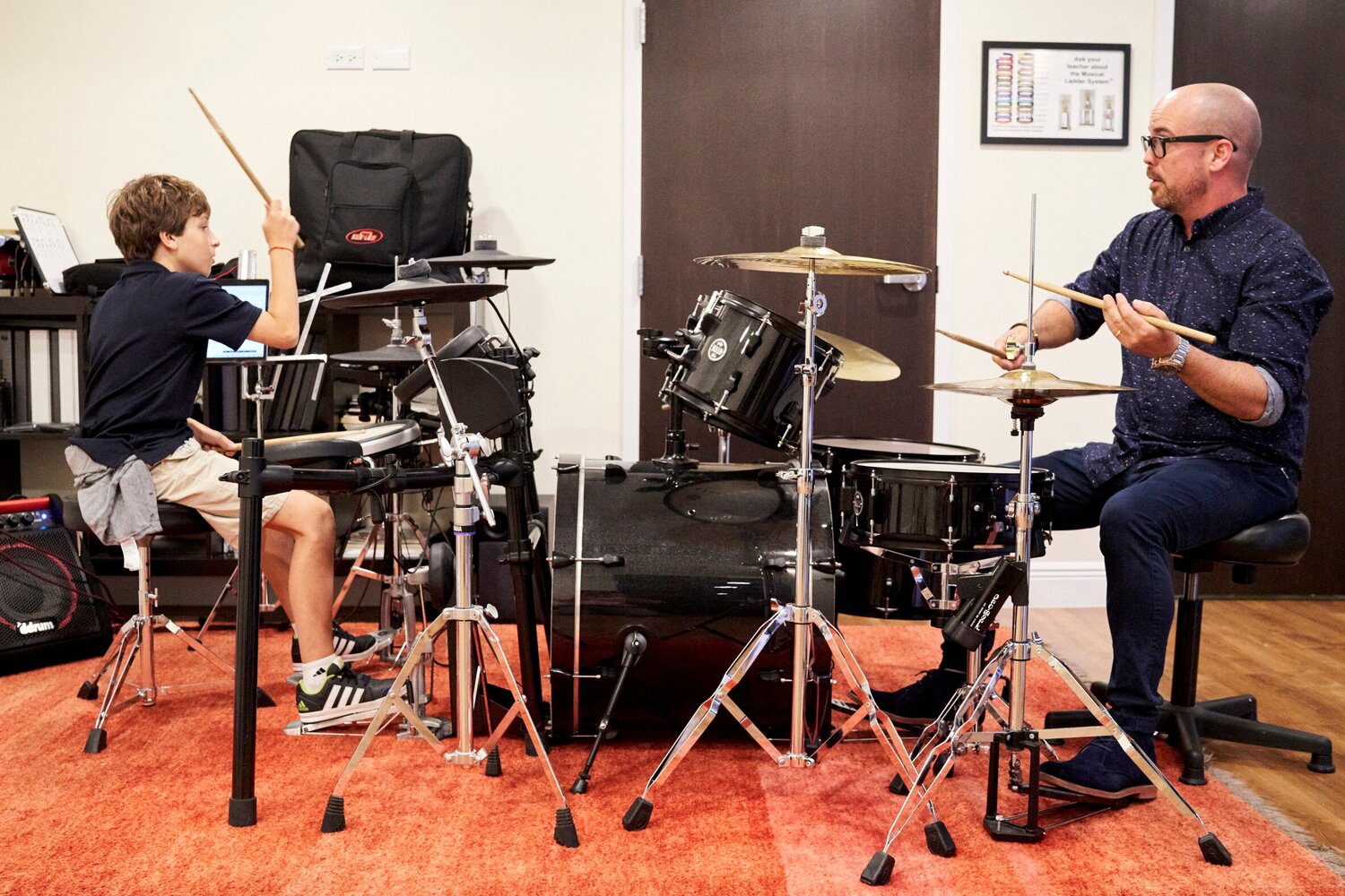 instructor teaching student drums