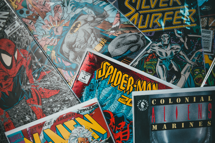 various comic books spread out on top of each other with their titles showing