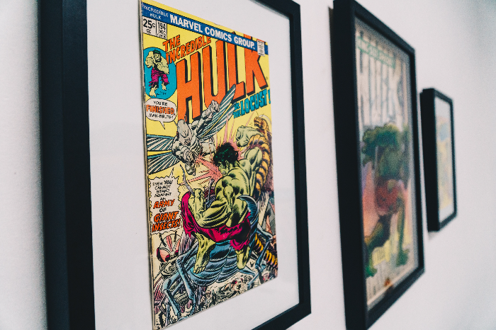 comics with the Hulk as the title framed in black frames on a white wall